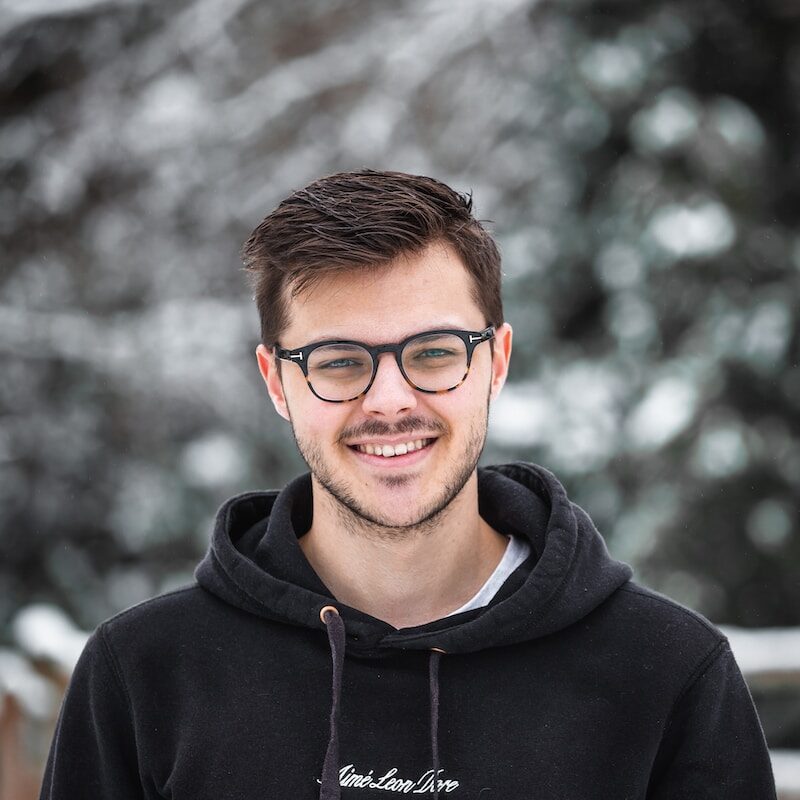 man in black hoodie wearing black framed eyeglasses