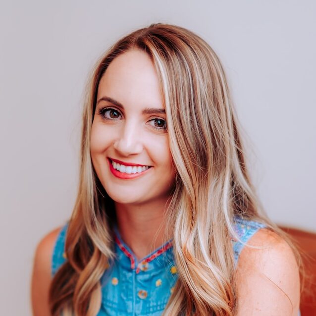 smiling girl in blue sleeveless dress