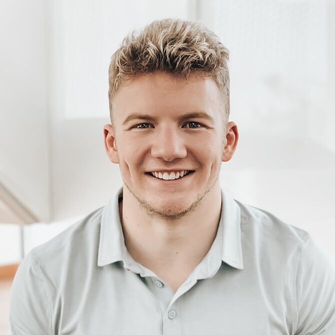 man in gray polo shirt smiling
