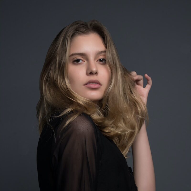 woman holding heft long blonde hair