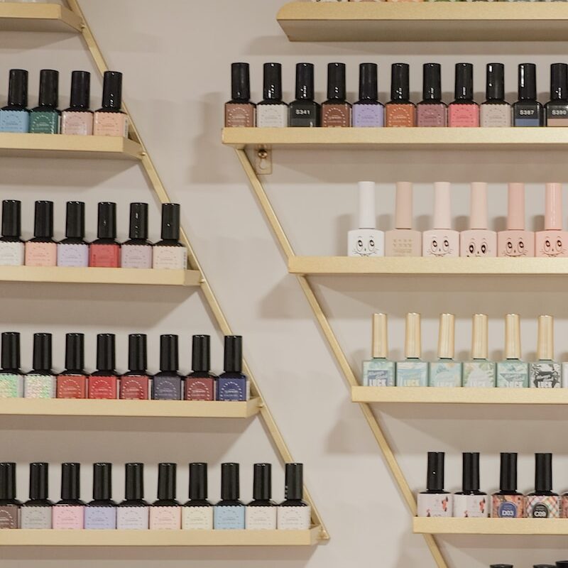 white and black bottles on brown wooden shelf